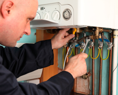 Plumber installing a boiler